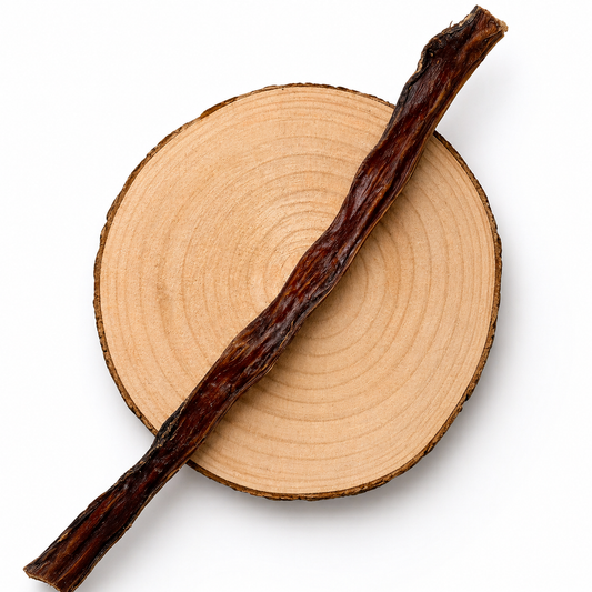 Beef biltong dog treat on wooden slice, natural high-protein chew for dogs.
