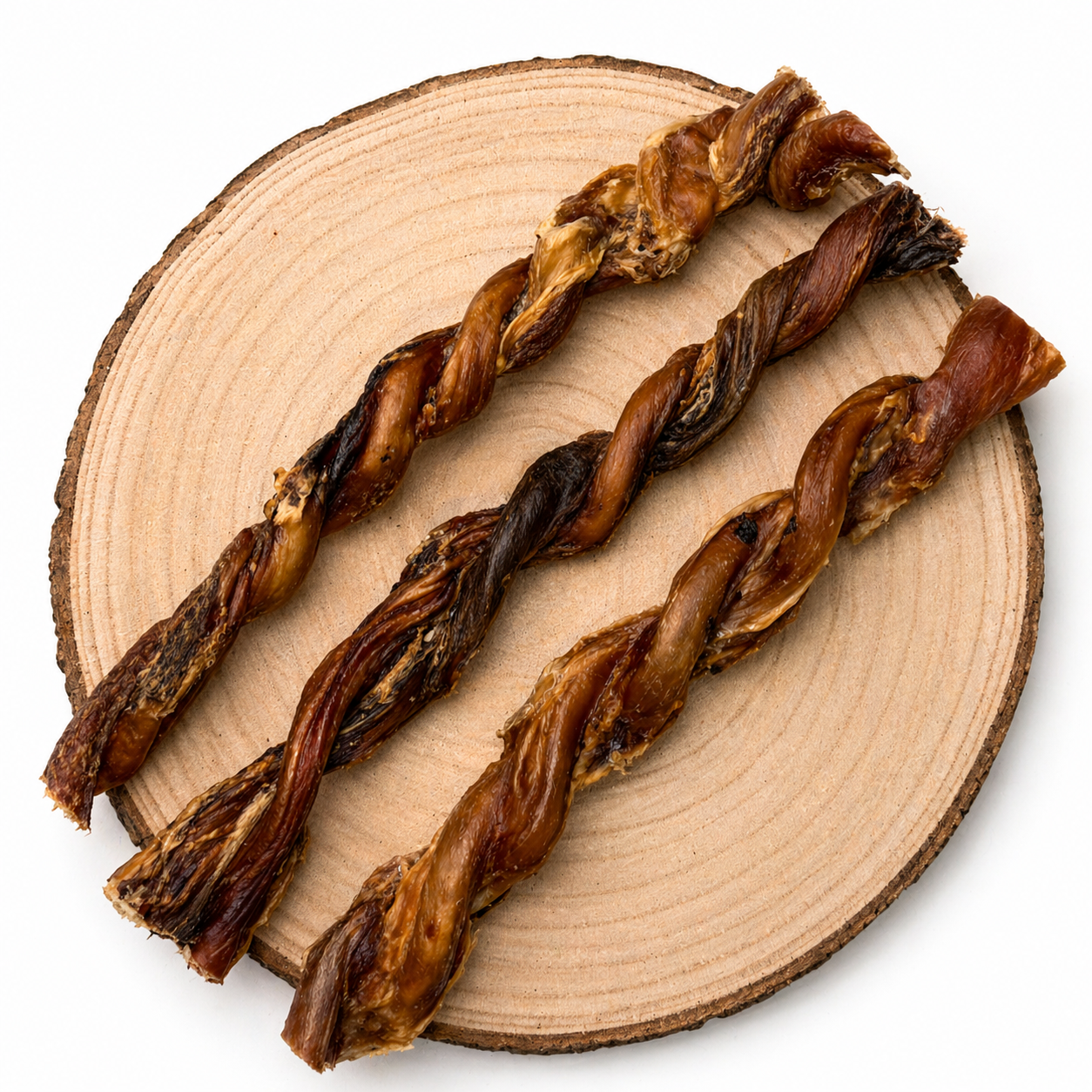 Twisted bull pizzles dog chews on wooden slice, natural high-protein long-lasting treats for dogs