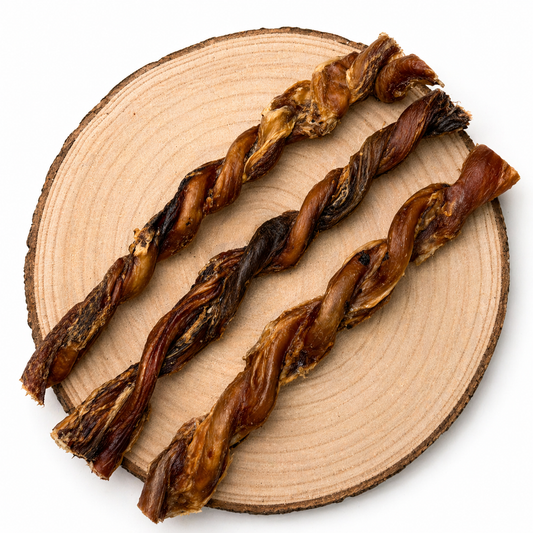 Twisted bull pizzles dog chews on wooden slice, natural high-protein long-lasting treats for dogs