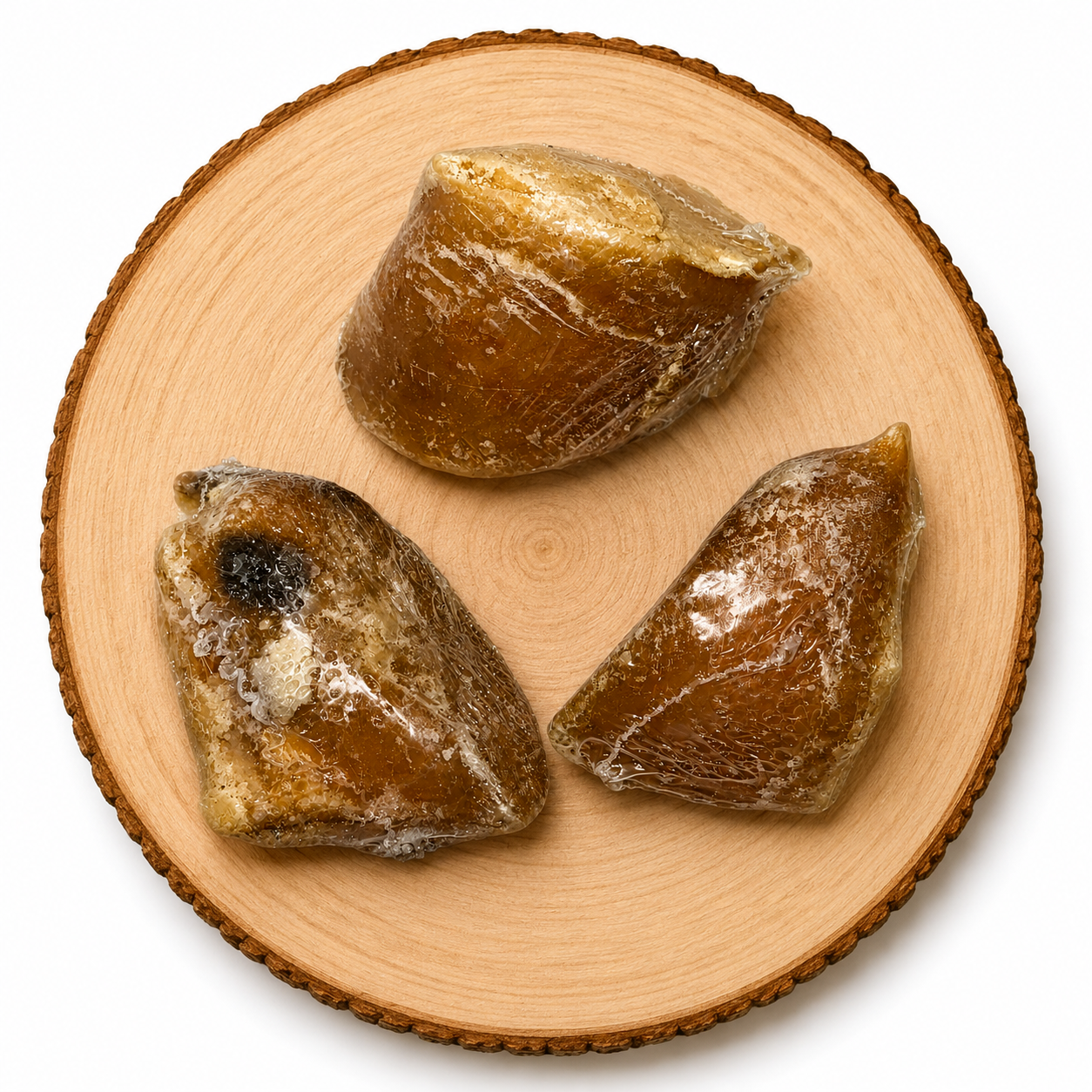 Natural beef hooves filled with nutritious sheep fat dog treats displayed on a wooden log – long lasting natural chew for dogs.
