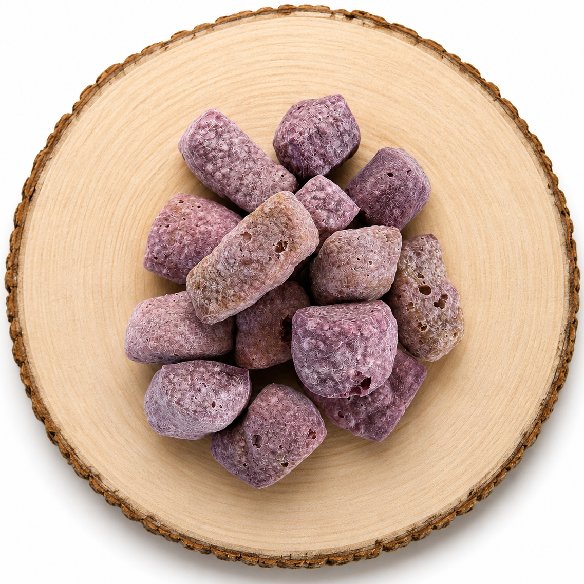 Blueberry yak puff dog treat on a wooden log.