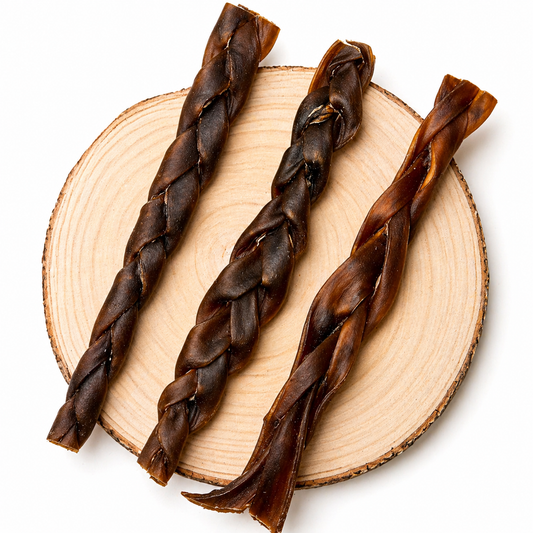 Braided camel dog chew sticks arranged on a natural wood slice, showcasing durable, twisted texture and rich brown colour natural long lasting dog treat for dental health and chewing.