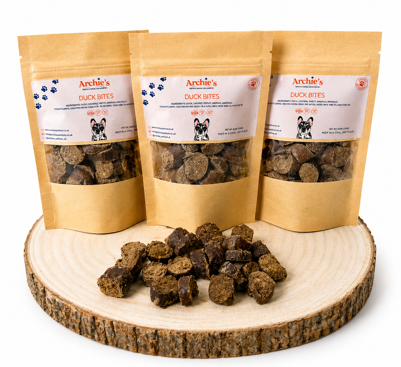 Duck bites dog treats in resealable pouches with natural training treats displayed on wooden log