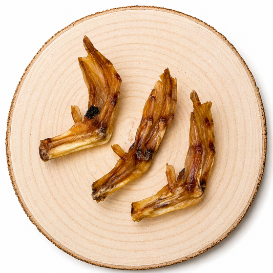 Dried duck feet dog treats arranged on wooden slab, natural protein crunchy chew for dogs
