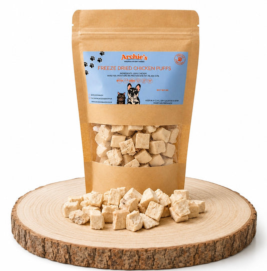 Freeze dried chicken dog and cat treats displayed on a wooden log.