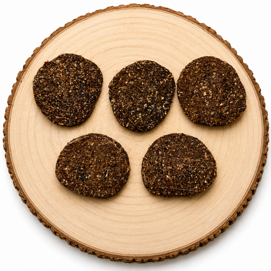 Gourmet burger dog treats displayed on a wooden log.