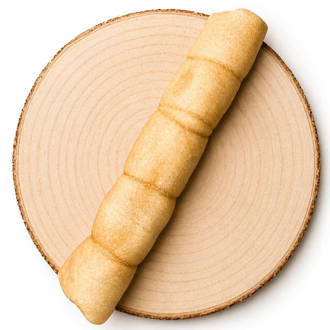 Jumbo buffalo roll dog treat displayed on wood slice, natural long-lasting chew for dogs