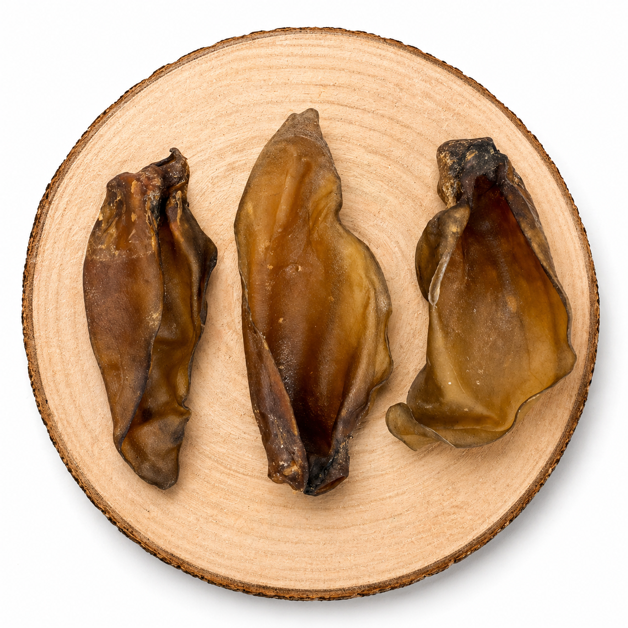 Large buffalo ears dog treats on wooden slice, natural long lasting high protein chew for dogs