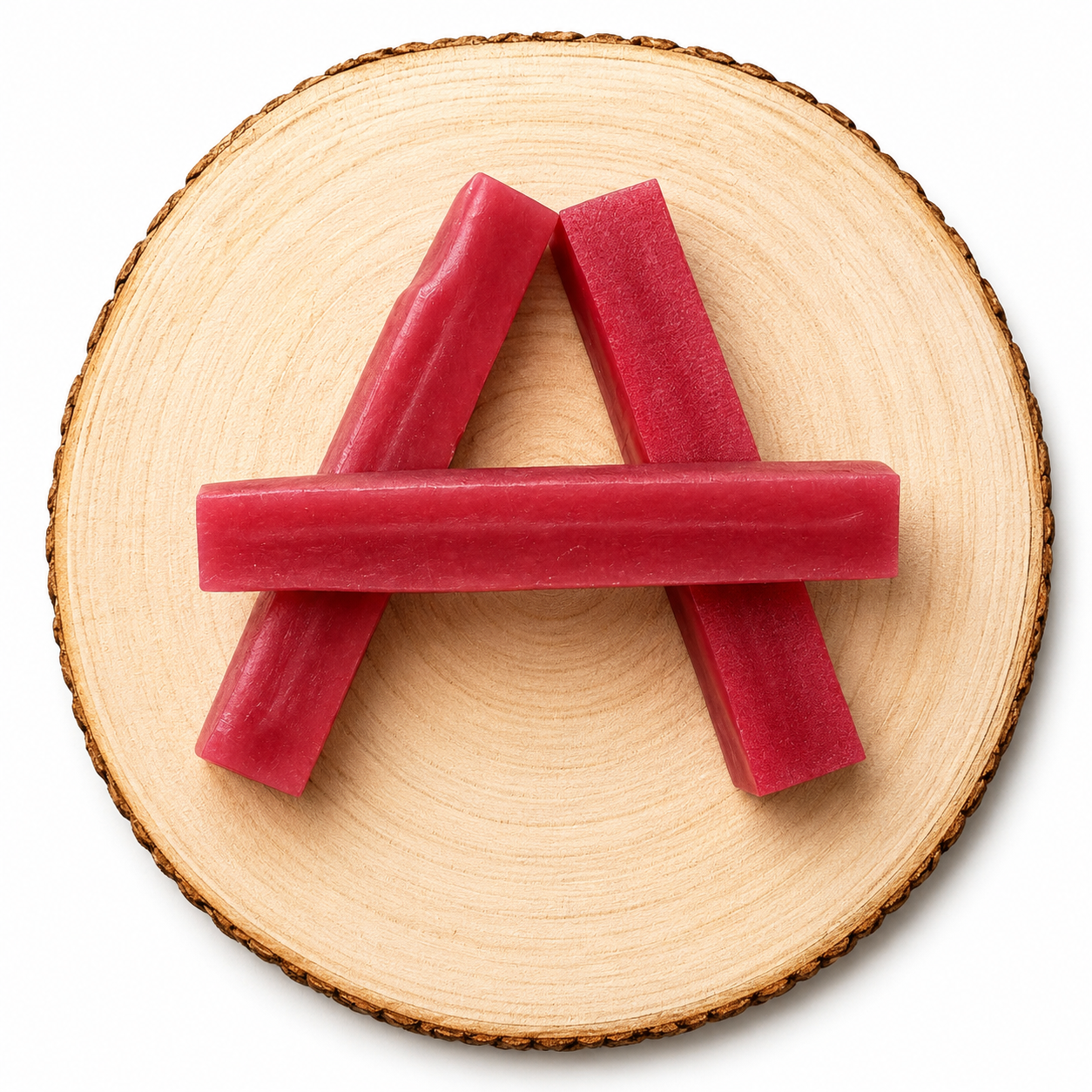 Raspberry yak dog chew on a wooden log.